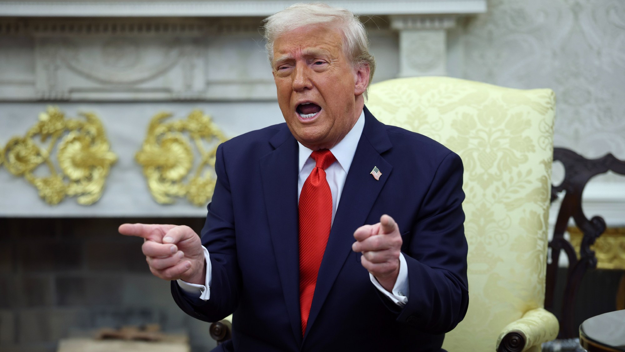 President Trump gestures during Oval Office meeting